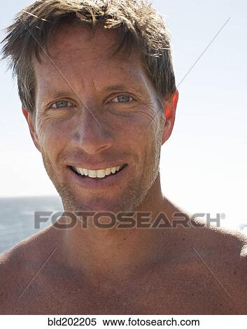 Smiling man at beach View Large Photo Image Stock Photography - Smiling man at beach. Fotosearch
