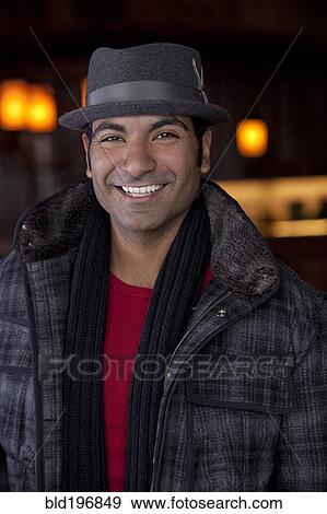 Smiling man wearing scarf and fedora View Large Photo Image Stock Photo - Smiling man wearing scarf and fedora. Fotosearch