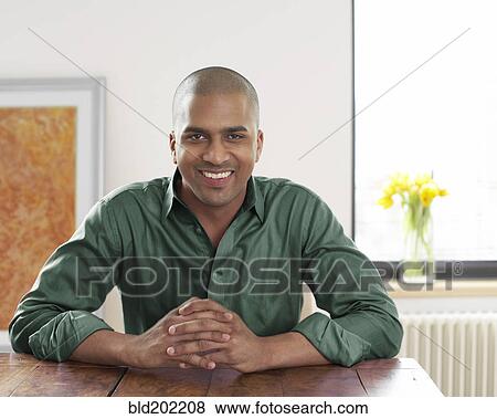 Smiling man with hands clasped View Large Photo Image Stock Photo - Smiling man with hands clasped. Fotosearch