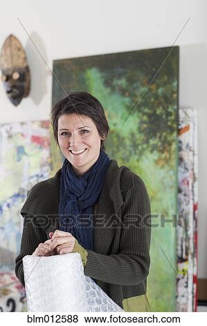 Stock Photo - Smiling mixed race art gallery curator. Fotosearch