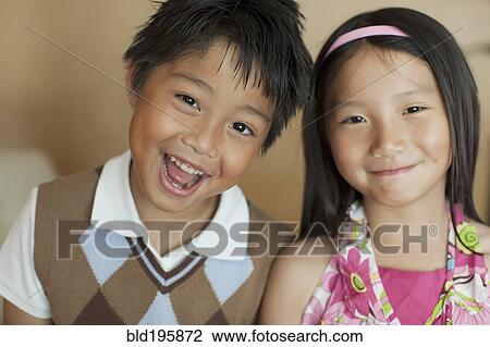 Stock Image - Smiling mixed race brother and sister. Fotosearch