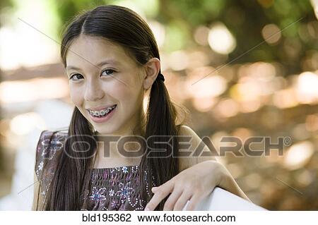 Smiling mixed race girl with braces View Large Photo Image Stock Image - Smiling mixed race girl with braces. Fotosearch