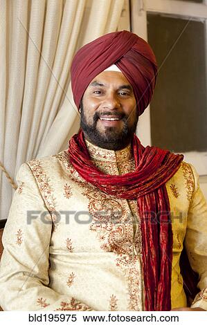 Stock Photography - Smiling mixed race man in traditional Indian clothing. Fotosearch