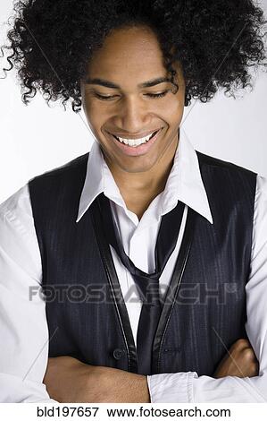 Stock Photo - Smiling mixed race man with arms crossed. Fotosearch