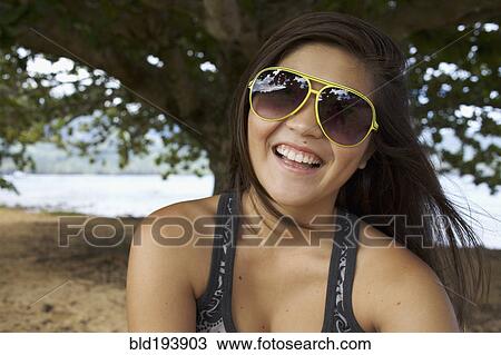 Smiling mixed race teenager in sunglasses View Large Photo Image Stock Image - Smiling mixed race teenager in sunglasses. Fotosearch