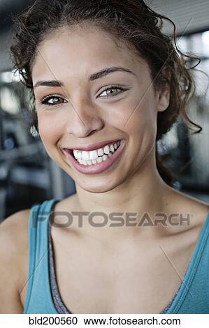 Stock Image - Smiling mixed race woman in health club. Fotosearch