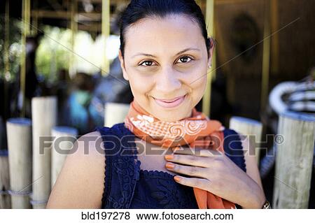 Stock Photo - Smiling mixed race woman in scarf. Fotosearch