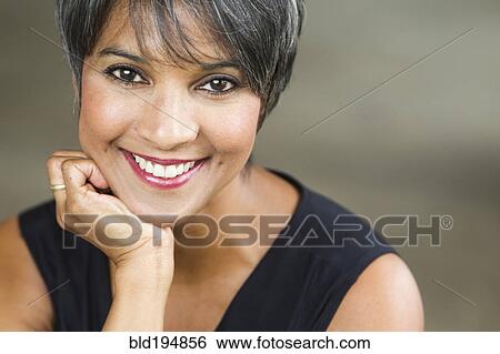 Stock Photograph - Smiling mixed race woman. Fotosearch