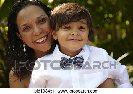 Smiling mother holding son on her lap View Large Photo Image Stock Image - Smiling mother holding son on her lap. Fotosearch