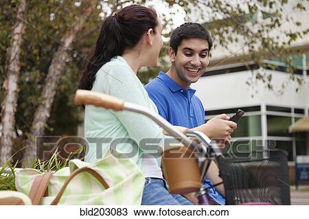 Stock Image - Smiling students talking on campus. Fotosearch