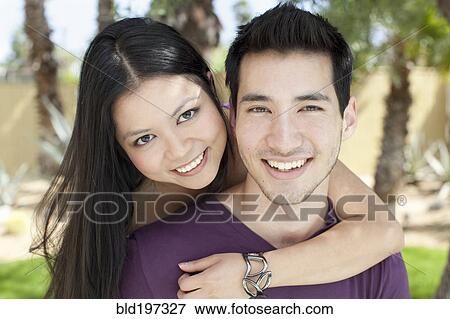 Stock Photo - Smiling woman hugging husband. Fotosearch