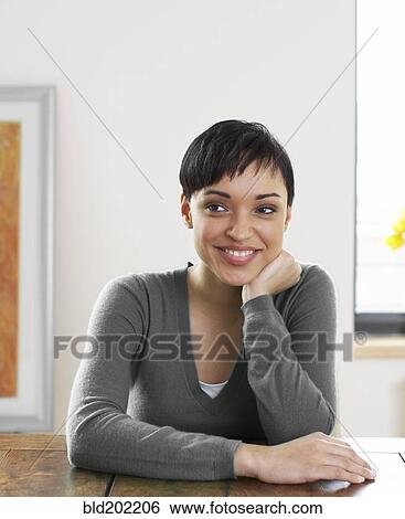 Smiling woman with hand on chin View Large Photo Image Stock Photograph - Smiling woman with hand on chin. Fotosearch