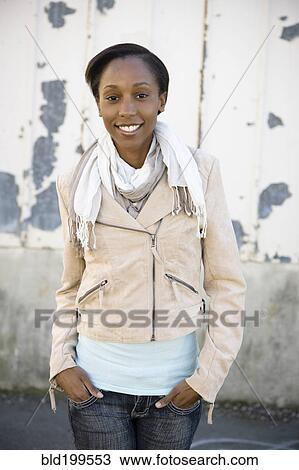 Smiling woman with hands in pockets View Large Photo Image Stock Image - Smiling woman with hands in pockets. Fotosearch