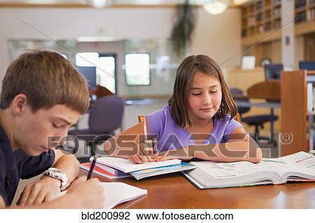Stock Image - Students studying in library. Fotosearch