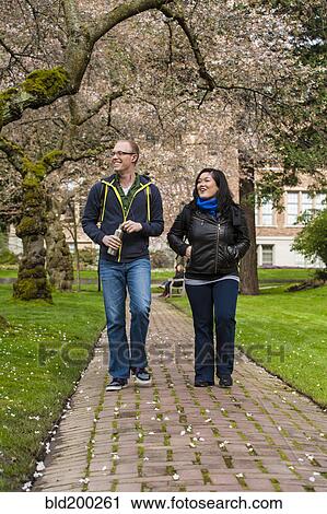 Stock Image - Students walking on campus together. Fotosearch