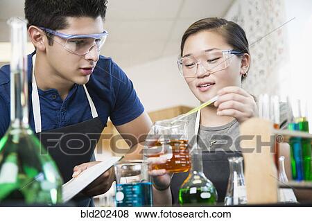 Stock Photo - Students working with chemicals in classroom. Fotosearch