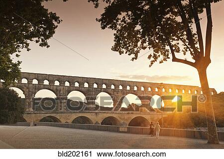 Sun shining through aqueduct View Large Photo Image Stock Image - Sun shining through aqueduct. Fotosearch