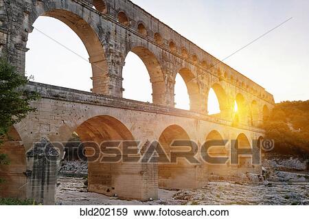 Stock Photo - Sun shining through aqueduct. Fotosearch