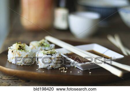 Stock Image - Sushi, sauce and chopsticks on tray. Fotosearch