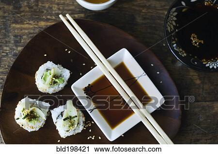 Stock Image - Sushi, sauce and chopsticks on tray. Fotosearch