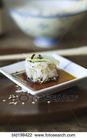 Stock Image - Sushi, sauce and chopsticks on tray. Fotosearch