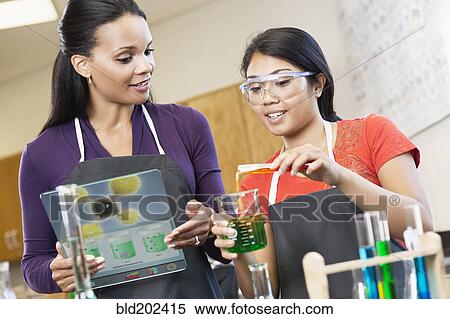 Teacher and student working with chemicals in classroom View Large Photo Image Stock Photography - Teacher and student working with chemicals in classroom. Fotosearch