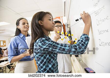 Picture - Teacher explaining chemistry model to students. Fotosearch