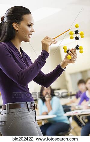 Teacher explaining chemistry model to classroom View Large Photo Image Stock Image - Teacher explaining chemistry model to classroom. Fotosearch