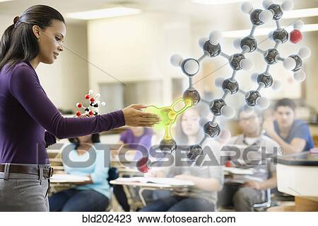 Stock Image - Teacher explaining chemistry model to classroom. Fotosearch