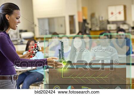 Picture - Teacher explaining the extraction process to classroom. Fotosearch
