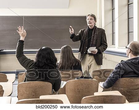 Teacher talking to students in classroom View Large Photo Image Stock Image - Teacher talking to students in classroom. Fotosearch