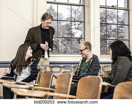 Teacher talking to students in classroom View Large Photo Image Stock Image - Teacher talking to students in classroom. Fotosearch