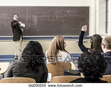 Stock Photography - Teacher talking to students in classroom. Fotosearch