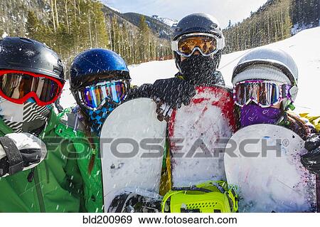 Teenagers snowboarding together View Large Photo Image Stock Photo - Teenagers snowboarding together. Fotosearch