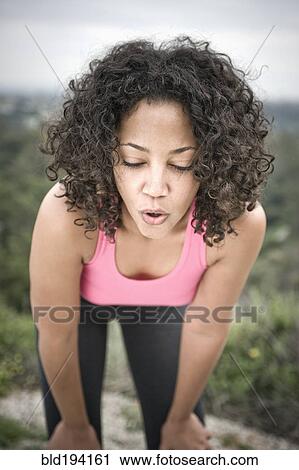 Tired woman resting after exercise View Large Photo Image Stock Image - Tired woman resting after exercise. Fotosearch