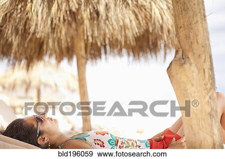 Tranquil Hispanic woman relaxing on vacation View Large Photo Image Stock Photo - Tranquil Hispanic woman relaxing on vacation. Fotosearch