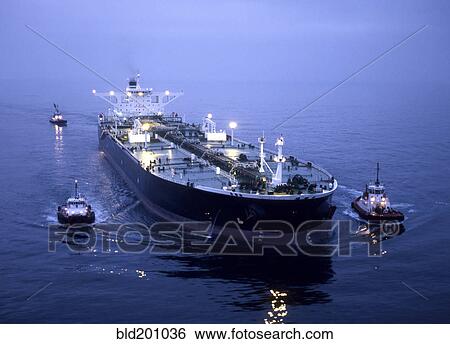 Stock Photograph - Tugboats and container ship in the port of Long Beach. Fotosearch
