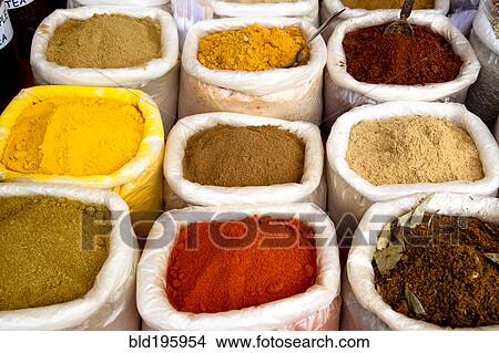 Picture - Variety of colorful Indian spices in sacks. Fotosearch