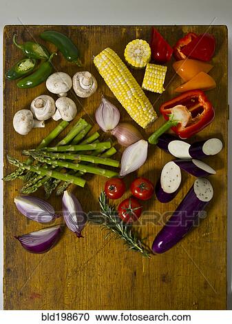 Variety of fresh vegetables on cutting board View Large Photo Image Stock Image - Variety of fresh vegetables on cutting board. Fotosearch