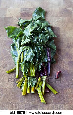 Stock Image - Various lettuces on cutting board. Fotosearch