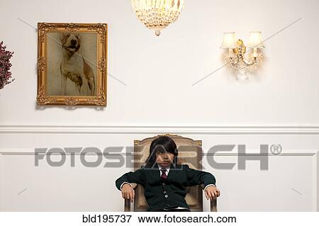 Stock Photo - Vietnamese boy sitting on elegant chair. Fotosearch