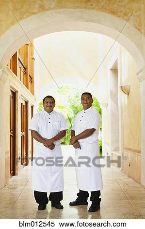 Stock Photography - Waiters in aprons standing in corridor. Fotosearch