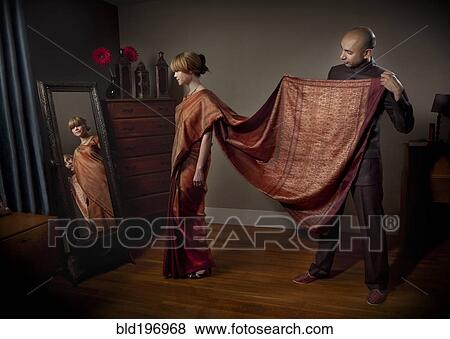 Stock Photo - Woman dressing in traditional Indian clothing. Fotosearch