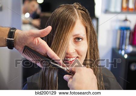 Stock Photo - Woman having haircut in salon. Fotosearch