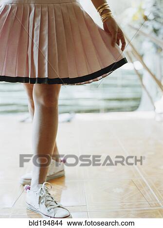 Woman in skirt and sneakers View Large Photo Image Picture - Woman in skirt and sneakers. Fotosearch