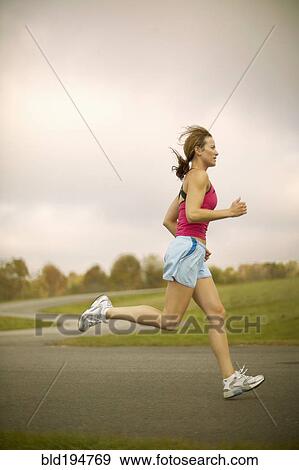 Stock Photo - Woman jogging on path. Fotosearch