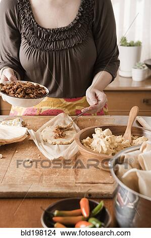 Picture - Woman making tamales. Fotosearch