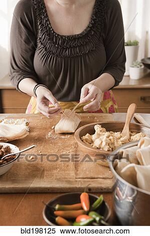 Stock Photography - Woman making tamales. Fotosearch