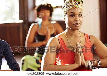 Woman meditating in yoga class View Large Photo Image Stock Photography - Woman meditating in yoga class. Fotosearch