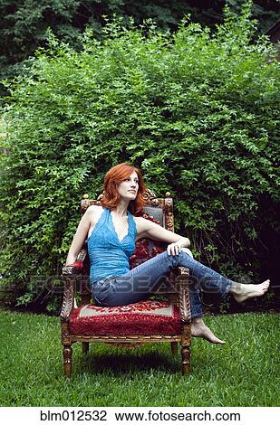 Woman relaxing outdoors in armchair View Large Photo Image Stock Image - Woman relaxing outdoors in armchair. Fotosearch